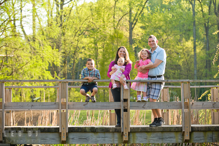 Family posing on the bridge. Washington DC, Silver Spring, Maryland candid children and family lifestyle photo session by photographers of Leo Dj Photography.