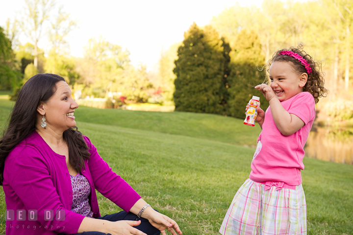 Mother and her daughter playing bubbles, laughing. Washington DC, Silver Spring, Maryland candid children and family lifestyle photo session by photographers of Leo Dj Photography.