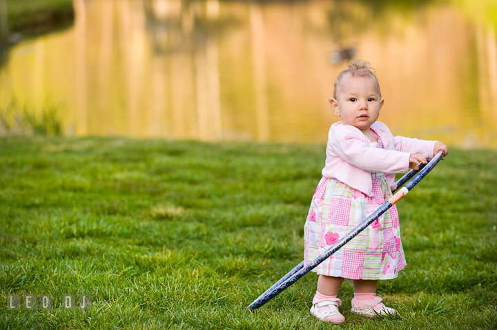 Baby girl playing a hula hoop. Washington DC, Silver Spring, Maryland candid children and family lifestyle photo session by photographers of Leo Dj Photography.