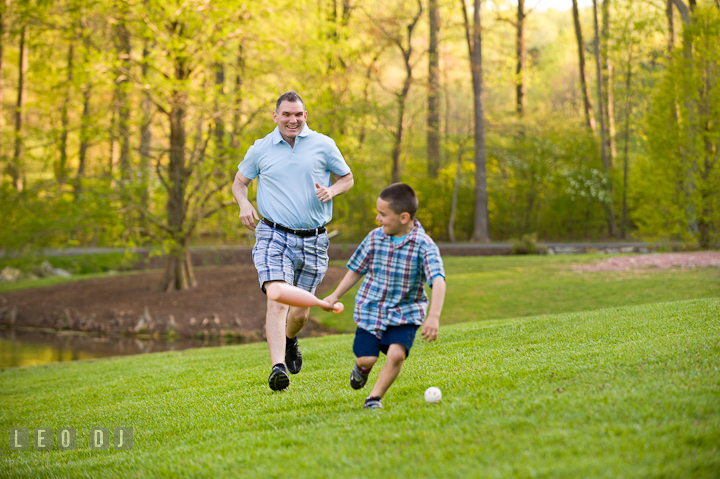 Dad chasing his running son. Washington DC, Silver Spring, Maryland candid children and family lifestyle photo session by photographers of Leo Dj Photography.