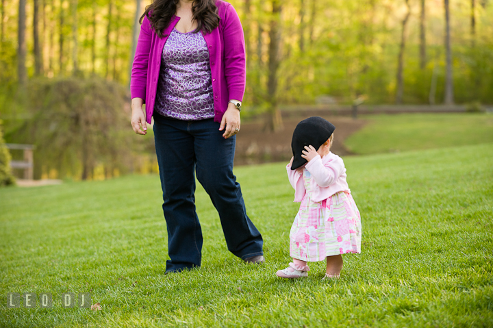 Baby girl trying on brother's hat. Washington DC, Silver Spring, Maryland candid children and family lifestyle photo session by photographers of Leo Dj Photography.