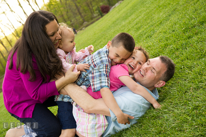 Family piling up against each other. Washington DC, Silver Spring, Maryland candid children and family lifestyle photo session by photographers of Leo Dj Photography.