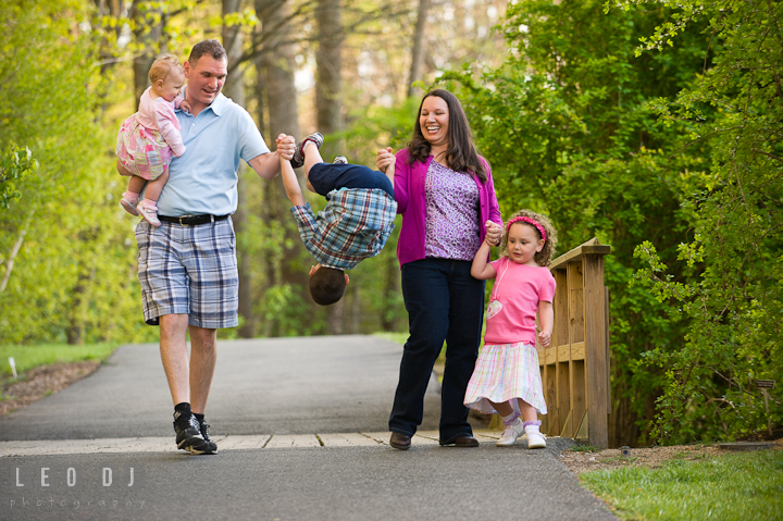 Family walking together, boy flipped in the air. Washington DC, Silver Spring, Maryland candid children and family lifestyle photo session by photographers of Leo Dj Photography.