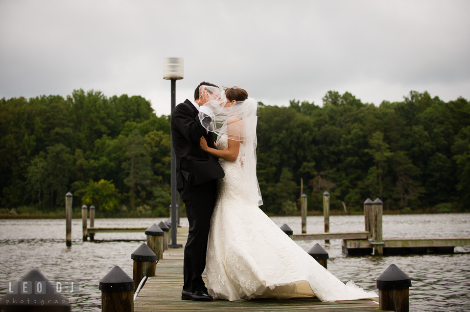 Bride and Groom kissing on the dock by the river. Aspen Wye River Conference Centers wedding at Queenstown Maryland, by wedding photographers of Leo Dj Photography. http://leodjphoto.com
