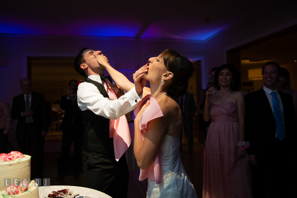 Bride and Groom feeding cakes and smashing cake onto each other. Aspen Wye River Conference Centers wedding at Queenstown Maryland, by wedding photographers of Leo Dj Photography. http://leodjphoto.com