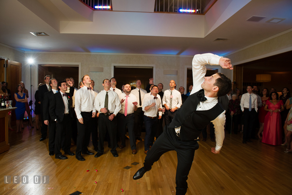 Groom tossing garter to male guests. Aspen Wye River Conference Centers wedding at Queenstown Maryland, by wedding photographers of Leo Dj Photography. http://leodjphoto.com