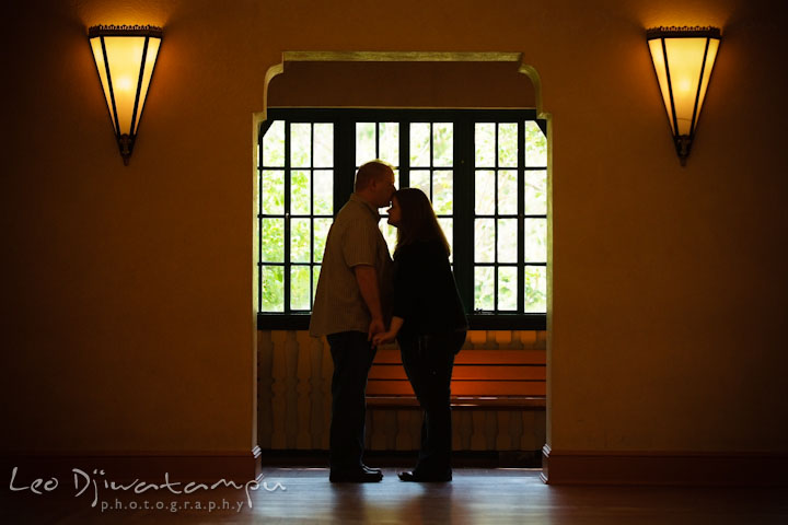 Engaged guy kissed his fiancée on her forehead. Pre wedding engagement photo session at Glen Echo Park Maryland by wedding photographer Leo Dj Photography