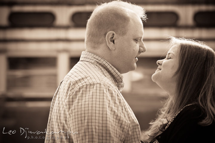 Engaged guy looking at his fiancée. Pre wedding engagement photo session at Glen Echo Park Maryland by wedding photographer Leo Dj Photography