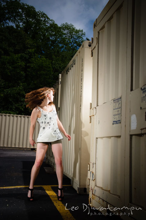 Girl model swinging hair looking at trailer storage containers. Lighting Essentials Workshops - Baltimore with Don Giannatti