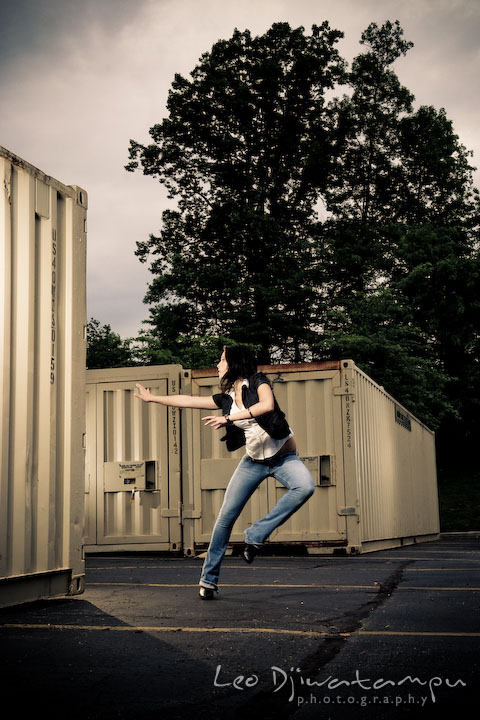 Girl model running away from something by storage containers. Lighting Essentials Workshops - Baltimore with Don Giannatti