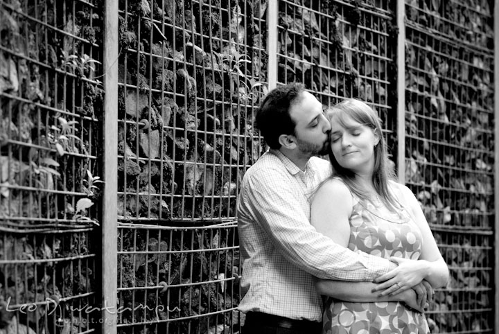 Engaged girl cuddled by her fiancé. Washington DC National Zoo pre-wedding engagement session by Leo Dj Photography