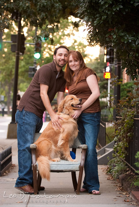 Engaged guy and girl posing with their dog on the curb. Dupont Circle Washington DC pre-wedding engagement session by Leo Dj Photography