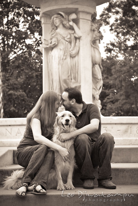 Engaged guy cuddling with his fiancée, with their dog in the middle. Dupont Circle Washington DC pre-wedding engagement session by Leo Dj Photography