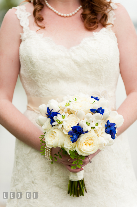 Bride holding her white rose floral bouquet. Harbourtowne Golf Resort wedding photos at St. Michaels, Eastern Shore, Maryland by photographers of Leo Dj Photography.