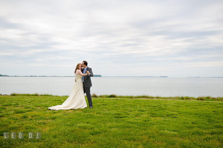 Bride and Groom slow dancing outside by the water. Harbourtowne Golf Resort wedding photos at St. Michaels, Eastern Shore, Maryland by photographers of Leo Dj Photography.