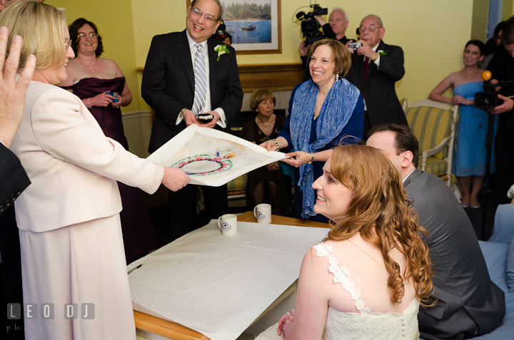 Bride and Groom's parent holding Ketubah during the signing ceremony. Harbourtowne Golf Resort wedding photos at St. Michaels, Eastern Shore, Maryland by photographers of Leo Dj Photography.