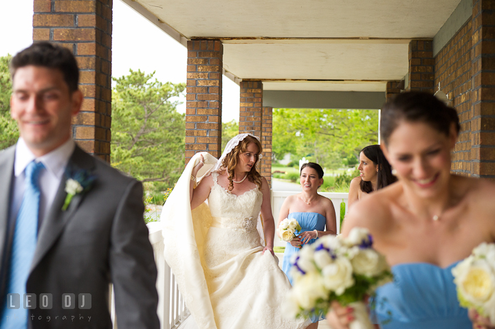 Bride and bridal party walking toward the ceremony site. Harbourtowne Golf Resort wedding photos at St. Michaels, Eastern Shore, Maryland by photographers of Leo Dj Photography.
