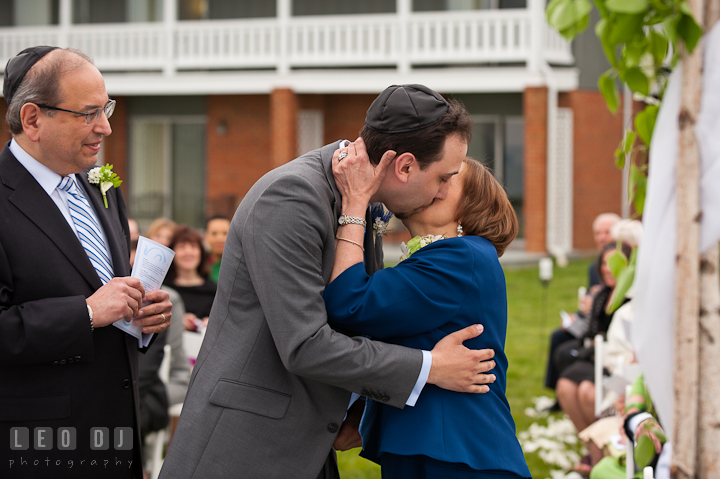 Mother of Groom kissed son during ceremony. Harbourtowne Golf Resort wedding photos at St. Michaels, Eastern Shore, Maryland by photographers of Leo Dj Photography.