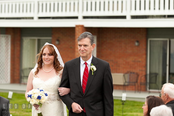 Father of Bride escorting daughter during procession ceremony. Harbourtowne Golf Resort wedding photos at St. Michaels, Eastern Shore, Maryland by photographers of Leo Dj Photography.