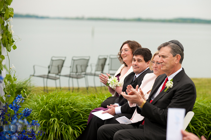 Bride and Groom's family clapping hands. Harbourtowne Golf Resort wedding photos at St. Michaels, Eastern Shore, Maryland by photographers of Leo Dj Photography.