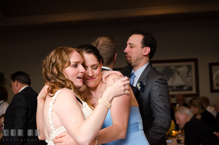 Bride hugging and dancing with best friend, Matron of Honor. Harbourtowne Golf Resort wedding photos at St. Michaels, Eastern Shore, Maryland by photographers of Leo Dj Photography.