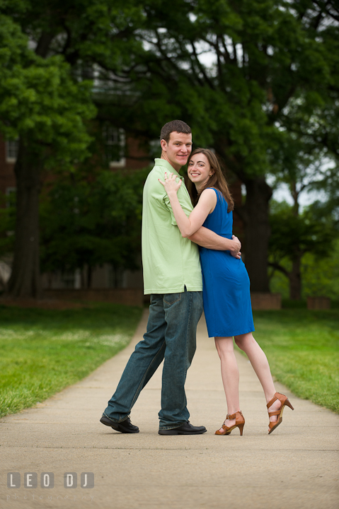 Engaged couple hugging. Pre-wedding or engagement photo session at University of Maryland at College Park campus by wedding photographers of Leo Dj Photography.