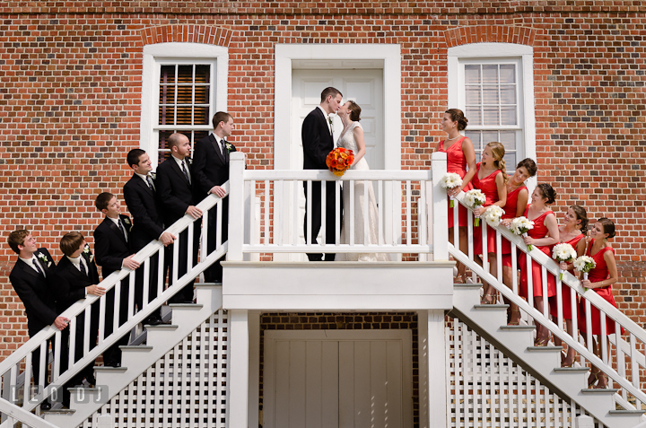 Groom party and Bridal party looking at Bride and Groom kissing. Historic London Town and Gardens wedding photos at Edgewater Annapolis, Maryland by photographers of Leo Dj Photography. http://leodjphoto.com