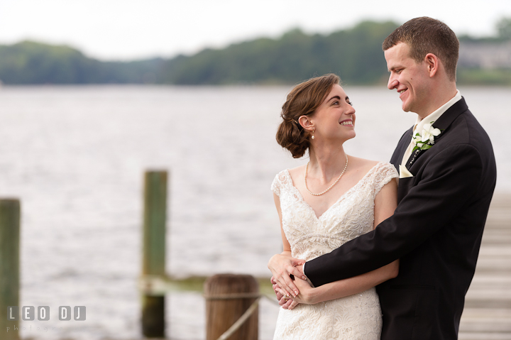 Bride and Groom cuddling and smiling. Historic London Town and Gardens wedding photos at Edgewater Annapolis, Maryland by photographers of Leo Dj Photography. http://leodjphoto.com