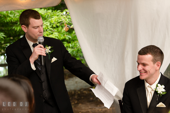 Groom smiling listening to Best Man's speech. Historic London Town and Gardens wedding photos at Edgewater Annapolis, Maryland by photographers of Leo Dj Photography. http://leodjphoto.com