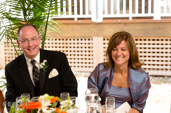 Father and Mother of Bride laughing listening to Best Man's speech. Historic London Town and Gardens wedding photos at Edgewater Annapolis, Maryland by photographers of Leo Dj Photography. http://leodjphoto.com