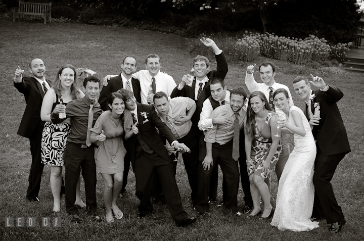 Bride and Groom posing for group shot with college alumni. Historic London Town and Gardens wedding photos at Edgewater Annapolis, Maryland by photographers of Leo Dj Photography. http://leodjphoto.com