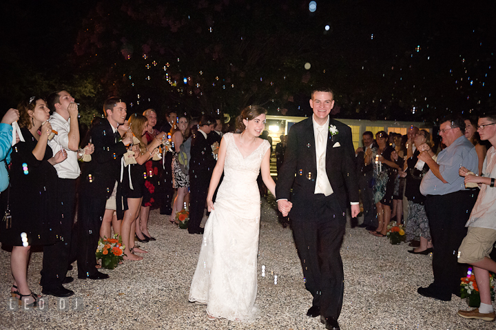 Guests sending off Bride and Groom by blowing bubbles. Historic London Town and Gardens wedding photos at Edgewater Annapolis, Maryland by photographers of Leo Dj Photography. http://leodjphoto.com