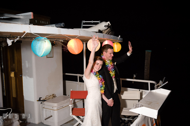 Bride and Groom waving from the boat. Historic London Town and Gardens wedding photos at Edgewater Annapolis, Maryland by photographers of Leo Dj Photography. http://leodjphoto.com