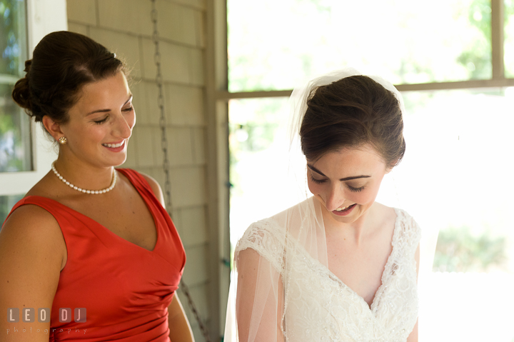 Bride and her Matron of Honor smiling together. Saint John the Evangelist church wedding ceremony photos at Severna Park, Maryland by photographers of Leo Dj Photography. http://leodjphoto.com