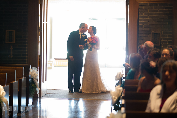 Father of Bride kissed daughter before escorting her down the isle. Saint John the Evangelist church wedding ceremony photos at Severna Park, Maryland by photographers of Leo Dj Photography. http://leodjphoto.com