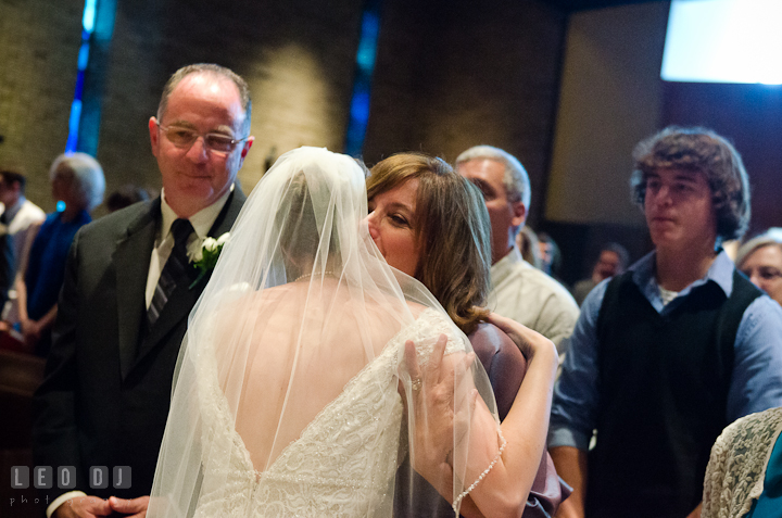 Bride hugging his Mother. Saint John the Evangelist church wedding ceremony photos at Severna Park, Maryland by photographers of Leo Dj Photography. http://leodjphoto.com