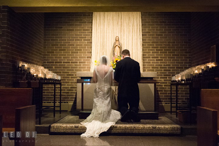 Bride and Groom making a devotion to Mother Mary. Saint John the Evangelist church wedding ceremony photos at Severna Park, Maryland by photographers of Leo Dj Photography. http://leodjphoto.com