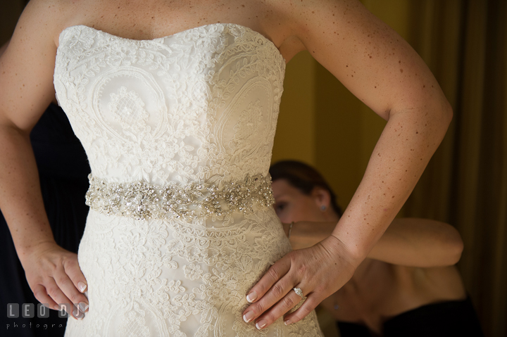 Bridesmaid help putting on Wedding gown on Bride. The Tidewater Inn wedding, Easton, Eastern Shore, Maryland, by wedding photographers of Leo Dj Photography. http://leodjphoto.com