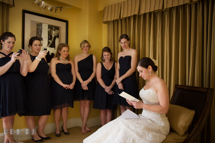 Bride reading letter and card from Groom as Maid of Honor and Bridesmaids watched. The Tidewater Inn wedding, Easton, Eastern Shore, Maryland, by wedding photographers of Leo Dj Photography. http://leodjphoto.com