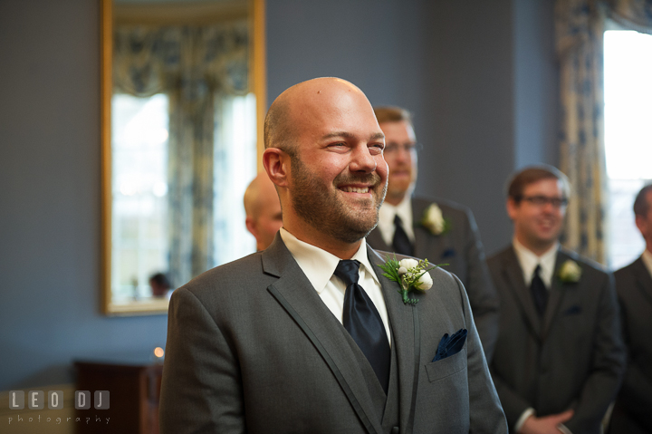 Groom smiling seeing Bride walking down the aisle during procession. The Tidewater Inn wedding, Easton, Eastern Shore, Maryland, by wedding photographers of Leo Dj Photography. http://leodjphoto.com