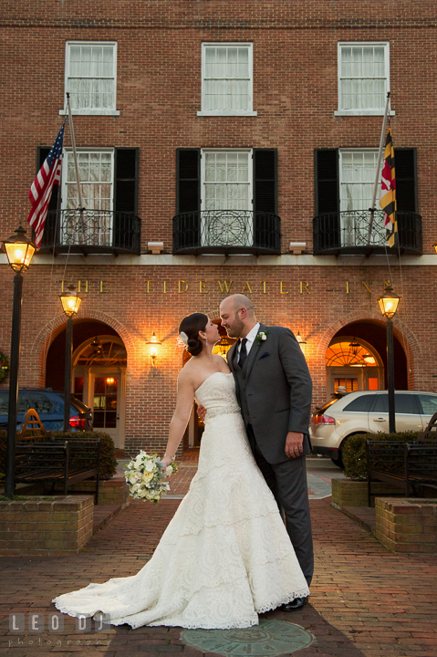 Bride holding bouquet by Monteray Farms almost kissed Groom in front of venue entrance. The Tidewater Inn wedding, Easton, Eastern Shore, Maryland, by wedding photographers of Leo Dj Photography. http://leodjphoto.com