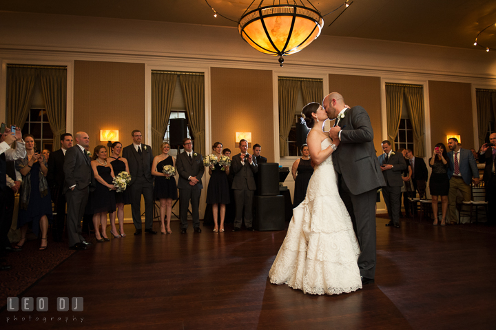 Groom and Bride kissing during first dance and observed by the wedding bridal party. The Tidewater Inn wedding, Easton, Eastern Shore, Maryland, by wedding photographers of Leo Dj Photography. http://leodjphoto.com