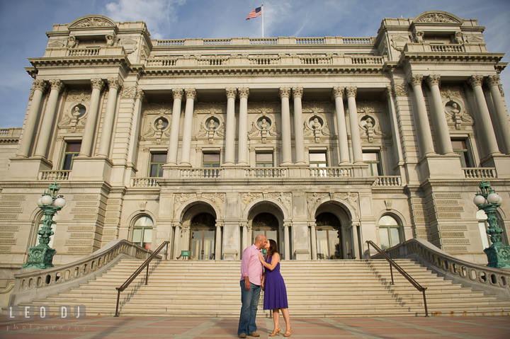 Engaged couple kissing in front of a beautiful antique building by the Capitol Hill. Washington DC pre-wedding engagement photo session, by wedding photographers of Leo Dj Photography. http://leodjphoto.com