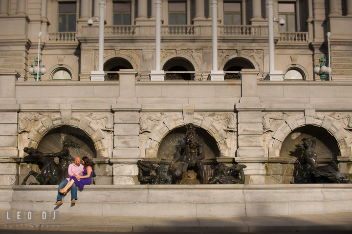 Engaged couple cuddling by the water fountains by the Capitol Hill. Washington DC pre-wedding engagement photo session, by wedding photographers of Leo Dj Photography. http://leodjphoto.com