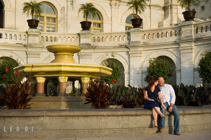 Engaged girl cuddling with her fiancé by the Capitol Hill. Washington DC pre-wedding engagement photo session, by wedding photographers of Leo Dj Photography. http://leodjphoto.com