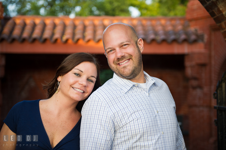 Engaged girl leaning against her fiancé and posing for the camera by the Capitol Hill. Washington DC pre-wedding engagement photo session, by wedding photographers of Leo Dj Photography. http://leodjphoto.com