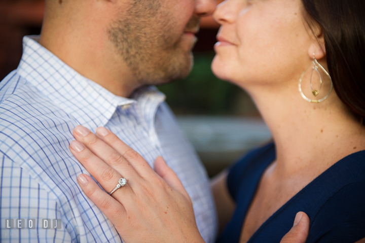 Engaged girl cuddling with her fiancé and showing her beautiful engagement ring. Washington DC pre-wedding engagement photo session, by wedding photographers of Leo Dj Photography. http://leodjphoto.com