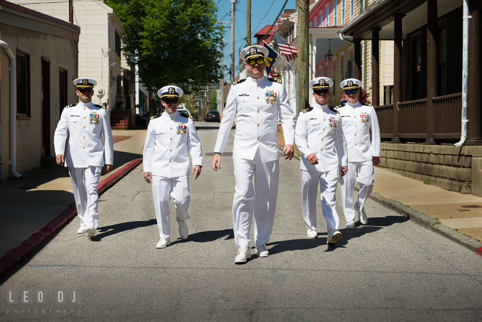 Groom and his groomsmen in Navy uniform walking down the street. USNA, US Naval Academy military wedding at Annapolis Maryland, by wedding photographers of Leo Dj Photography. http://leodjphoto.com