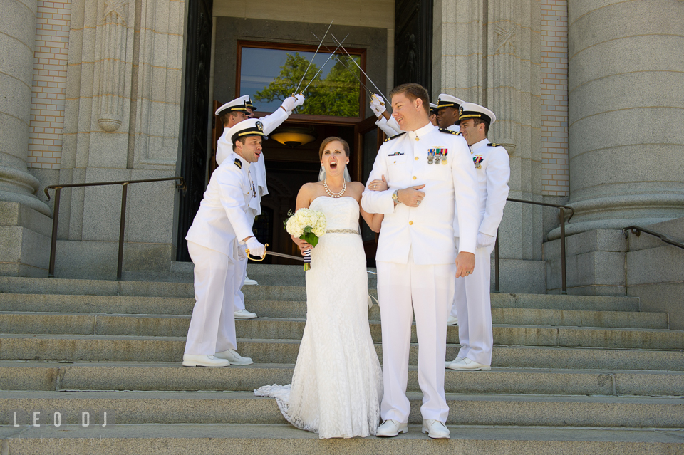 Swordsman swat Bride's behind as they walk under the arch of swords. USNA, US Naval Academy military wedding at Annapolis Maryland, by wedding photographers of Leo Dj Photography. http://leodjphoto.com
