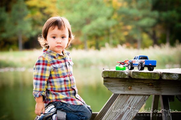 cute boy kid in flanel shirt on picnic table bench with toy truck. Commercial comp card photograper Kent Island Annapolis MD Washington DC